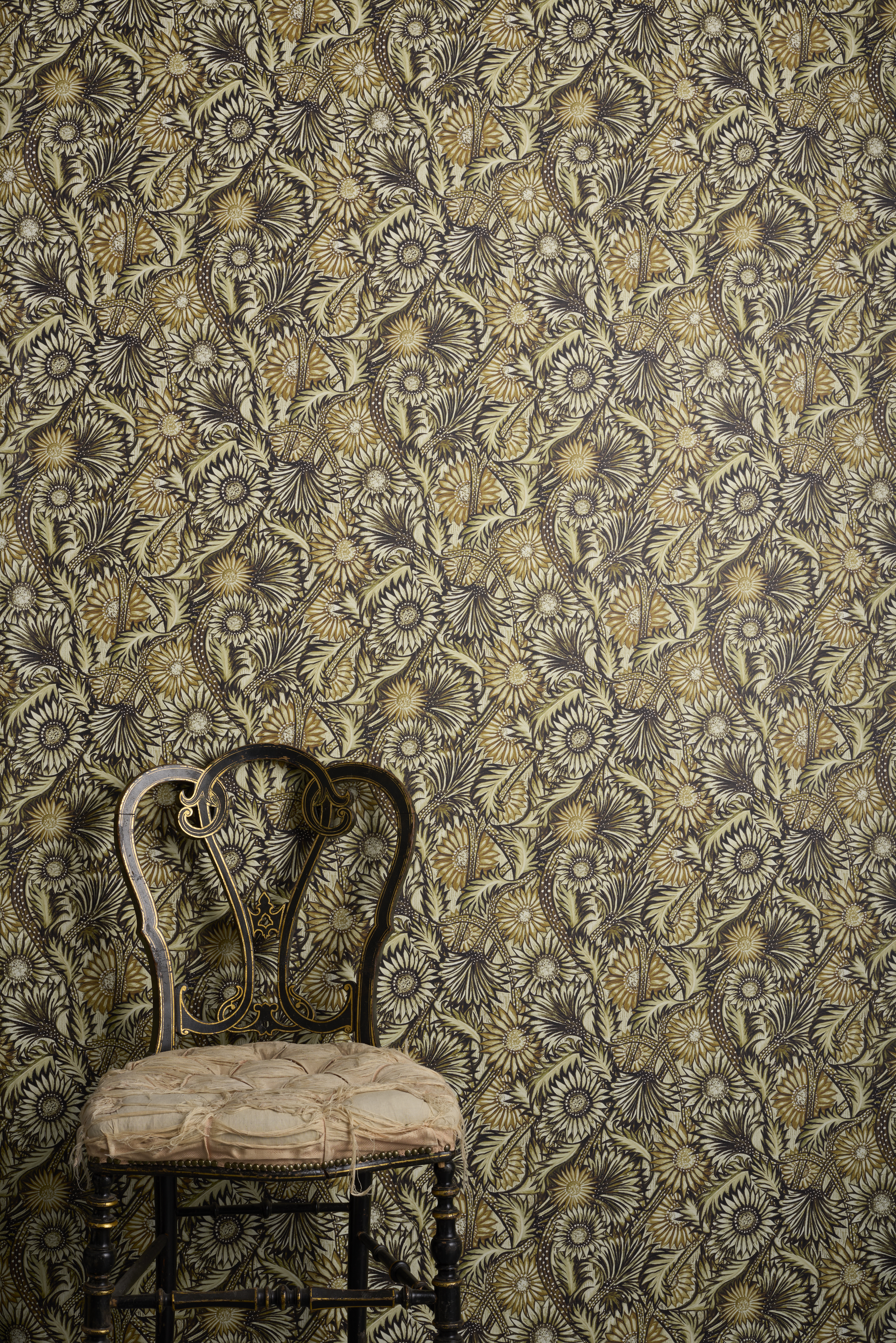 Rapture Lucite floral pattern wallpaper in tones of green and mustard yellow